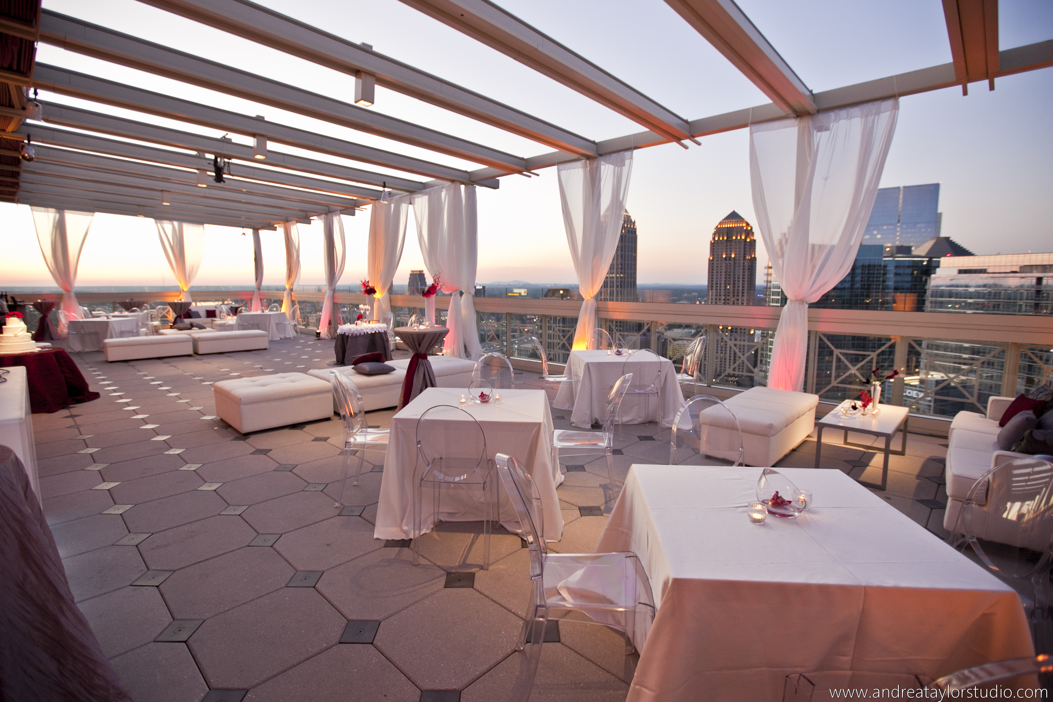 Luxury event environment with ambient lighting, elegant tables, and soft floral centerpieces. 