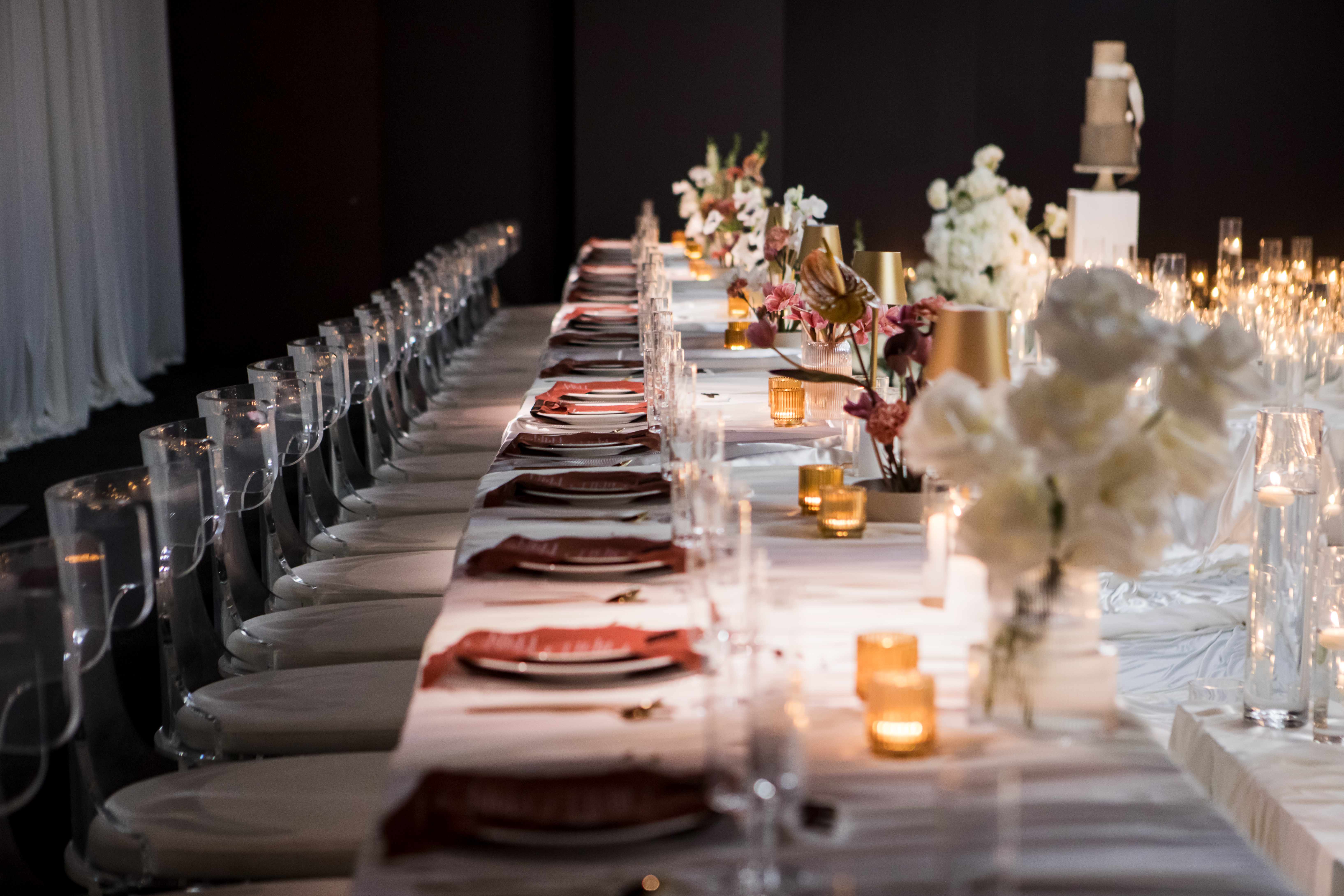 Elegant luxury dinner table set with warm ambient candle lighting and floral accents